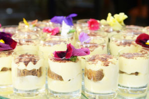Custard desserts in glass holders decorated with flowers